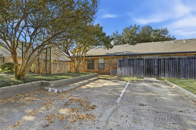 a backyard of a house with table and chairs