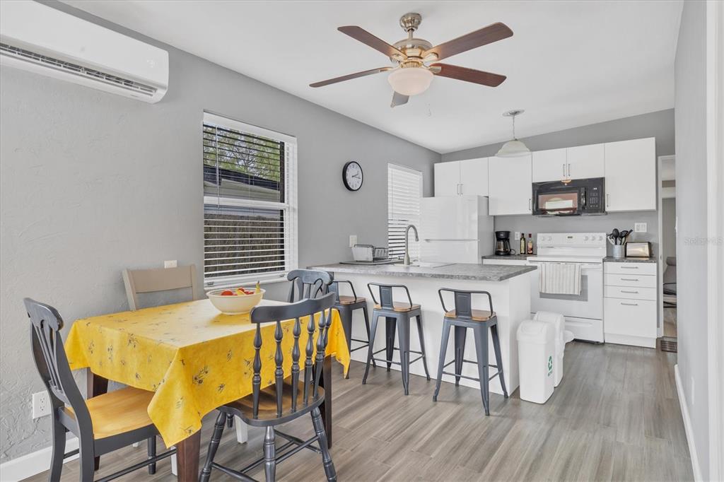 2305 Novus Street Sarasota, FL 34237 - Photo 16 of 28 a view of a dining room with furniture and wooden floor