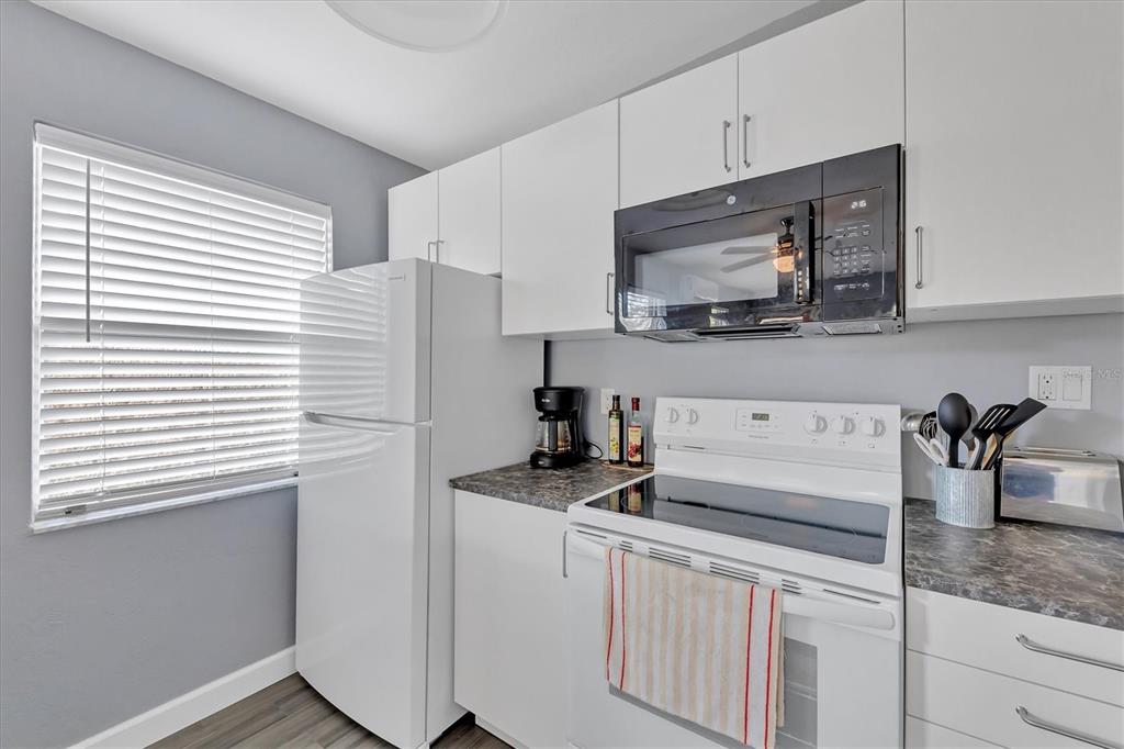 2305 Novus Street Sarasota, FL 34237 - Photo 19 of 28 a kitchen with stainless steel appliances granite countertop a sink stove and microwave