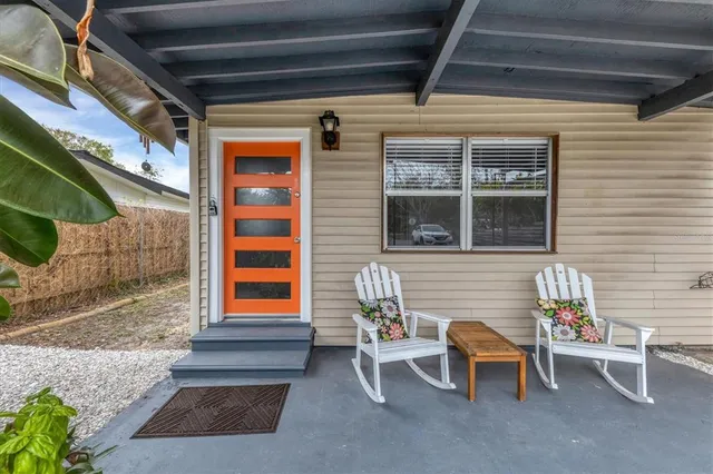 a front view of a house with outdoor seating