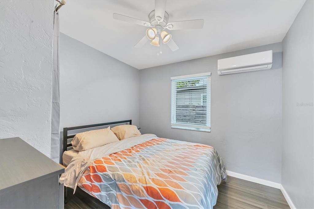 2305 Novus Street Sarasota, FL 34237 - Photo 5 of 28 a bedroom with a bed and a chandelier