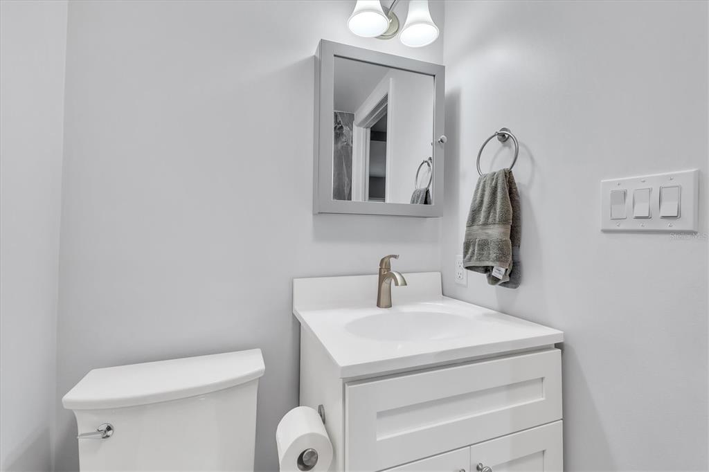 2305 Novus Street Sarasota, FL 34237 - Photo 9 of 28 a bathroom with a toilet sink and mirror