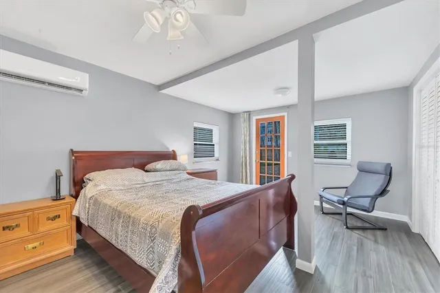 a bedroom with a bed and wooden floor