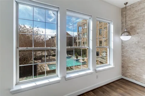 a view of a room that has a window and wooden floor