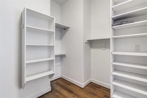 a view of walk in closet with empty racks