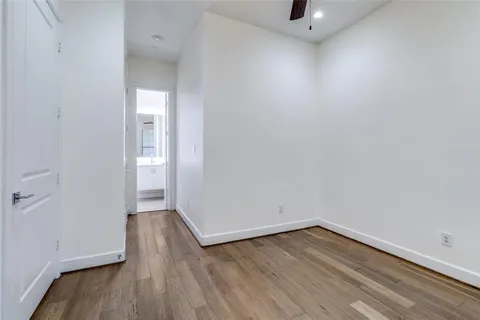 a view of a room with wooden floor and a sink