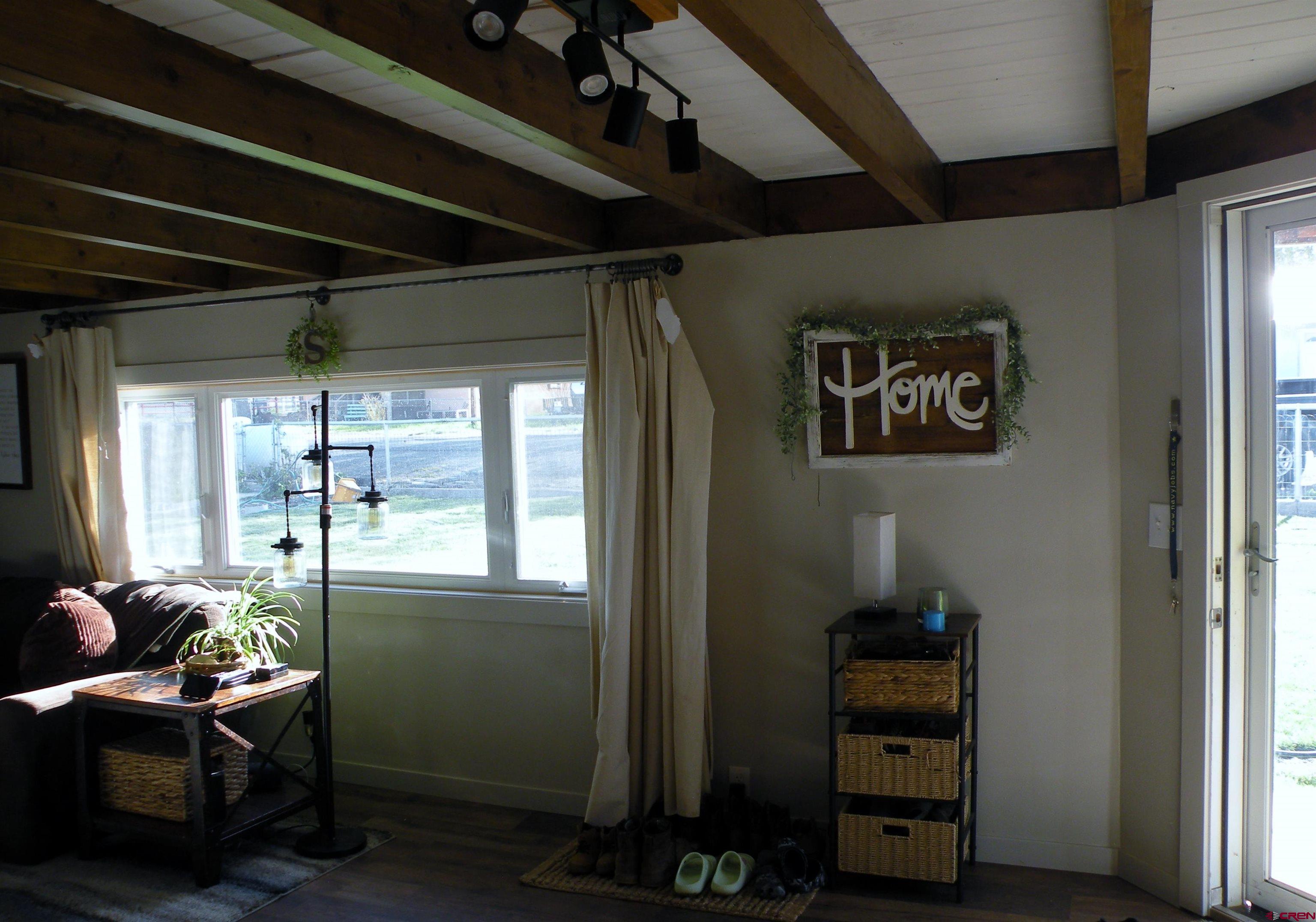 810 Grape Street Nucla, CO 81424 - Photo 15 of 31 a room with furniture a chandelier and a window