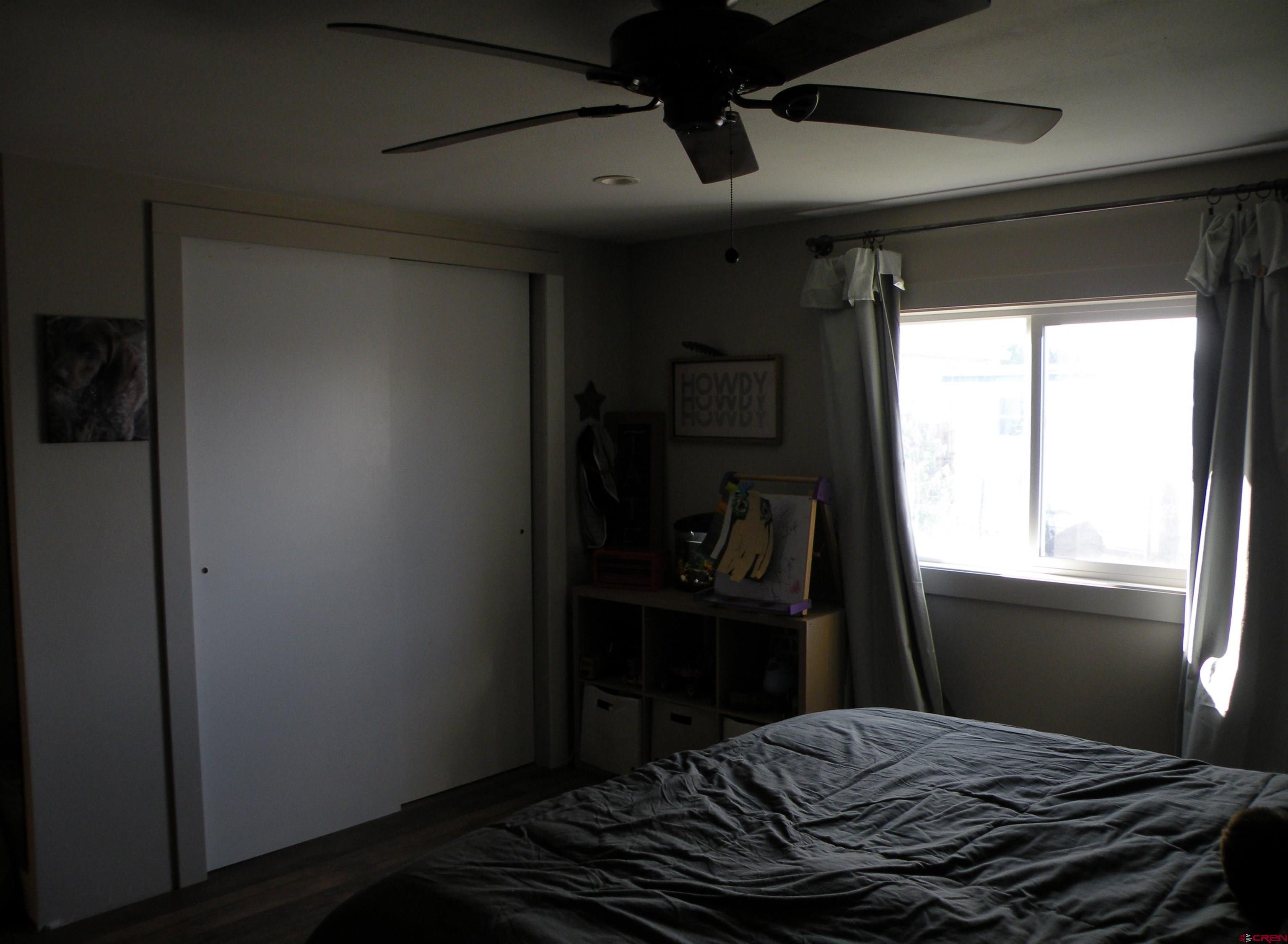 810 Grape Street Nucla, CO 81424 - Photo 29 of 31 a bedroom with a bed and a window