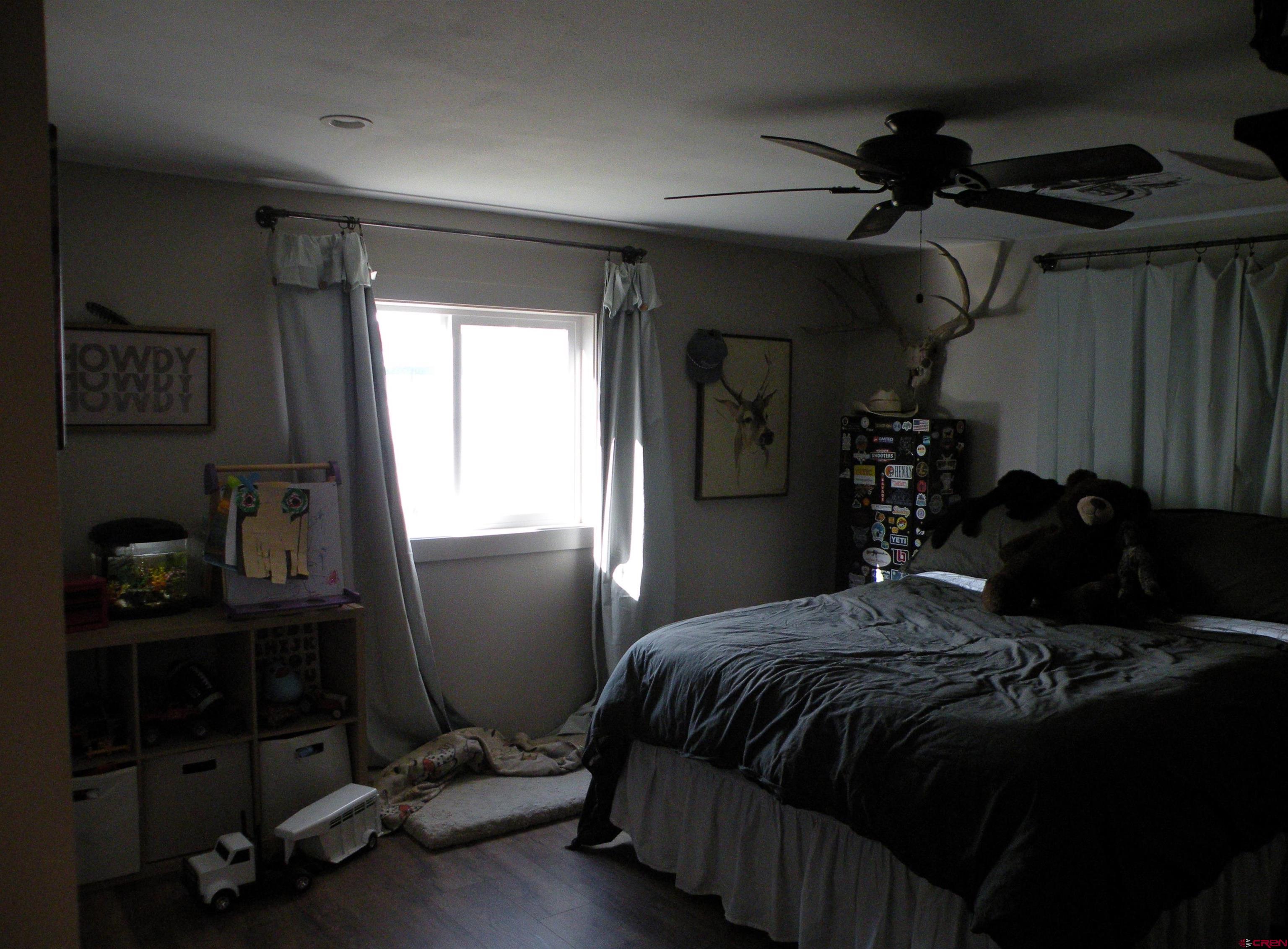 810 Grape Street Nucla, CO 81424 - Photo 31 of 31 a bedroom with a bed and a window