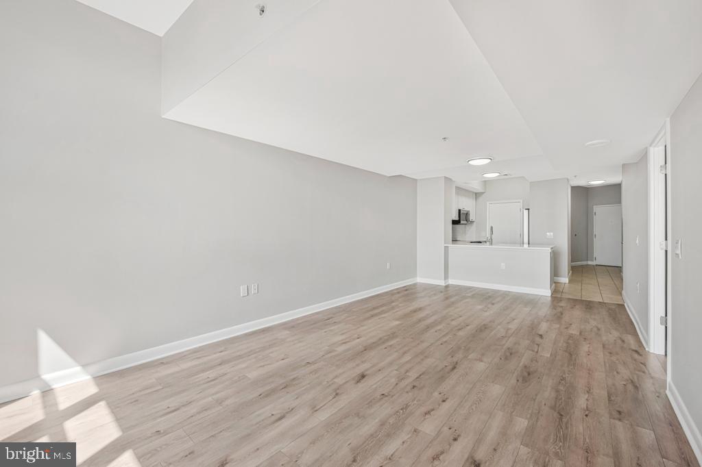 400 Massachusetts Avenue Northwest, Unit 1322 Washington, DC 20001 - Photo 11 of 37 a view of a big room with wooden floor and windows