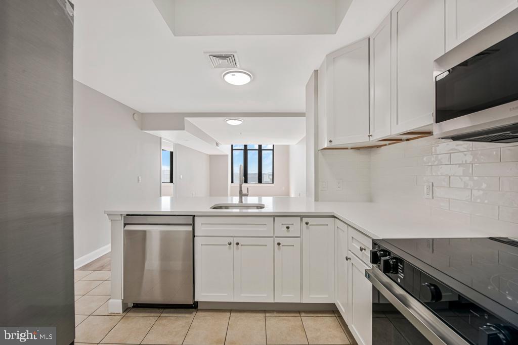400 Massachusetts Avenue Northwest, Unit 1322 Washington, DC 20001 - Photo 16 of 37 a kitchen with a sink and cabinets