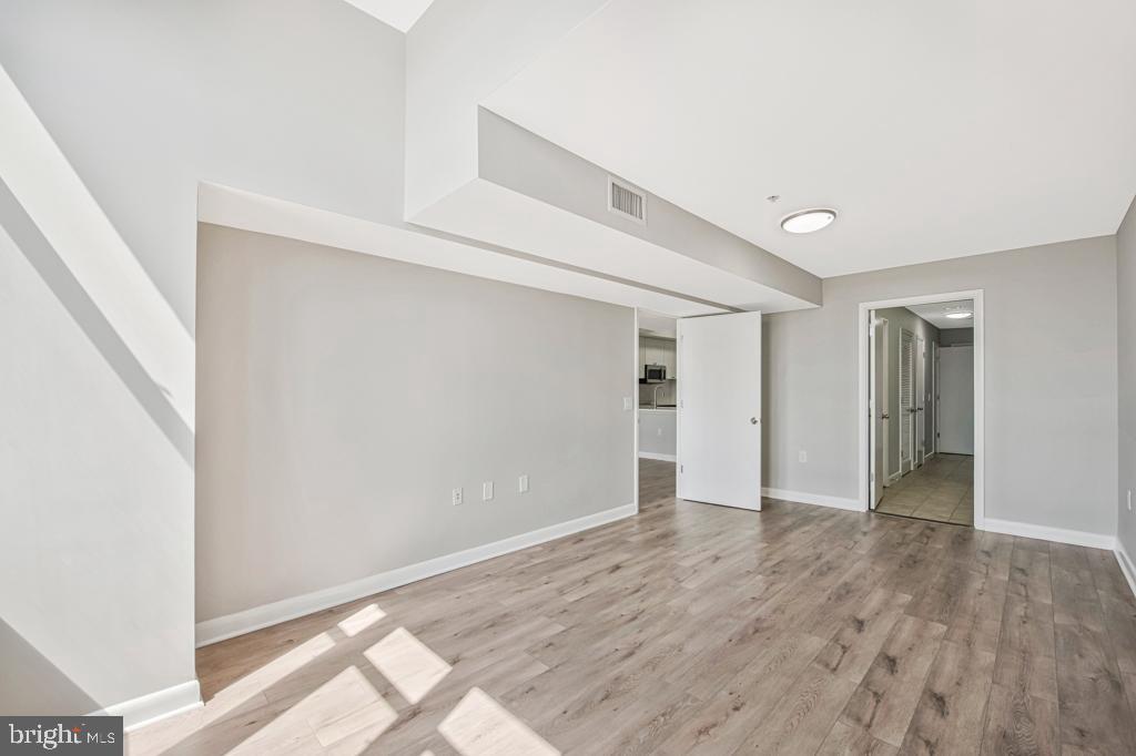 400 Massachusetts Avenue Northwest, Unit 1322 Washington, DC 20001 - Photo 20 of 37 a view of an empty room with wooden floor and closet