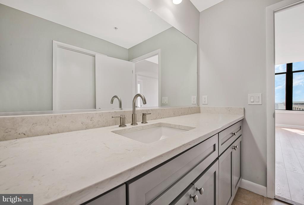 400 Massachusetts Avenue Northwest, Unit 1322 Washington, DC 20001 - Photo 24 of 37 a bathroom with a sink and a mirror