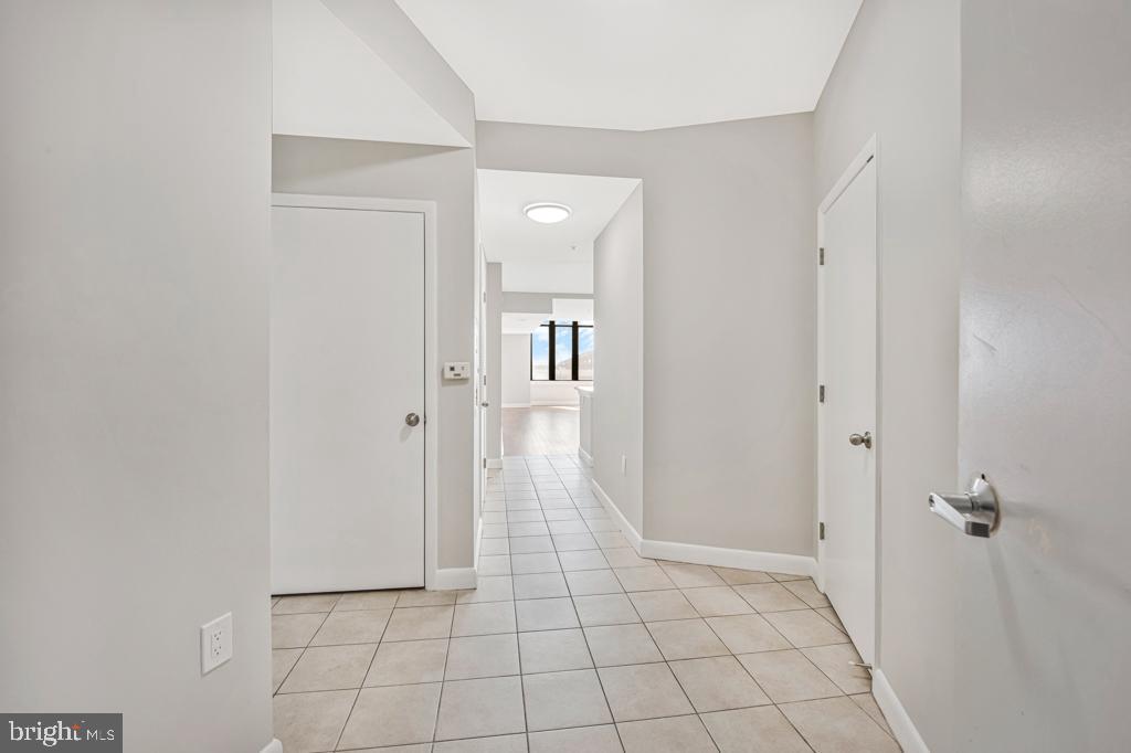 400 Massachusetts Avenue Northwest, Unit 1322 Washington, DC 20001 - Photo 27 of 37 a view of a hallway with wooden floor and a bathroom