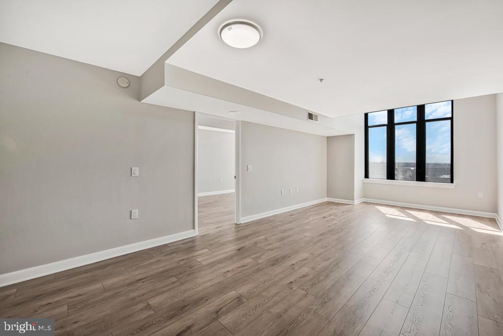 400 Massachusetts Avenue Northwest, Unit 1322 Washington, DC 20001 - Photo 30 of 37 a view of an empty room with wooden floor and a window