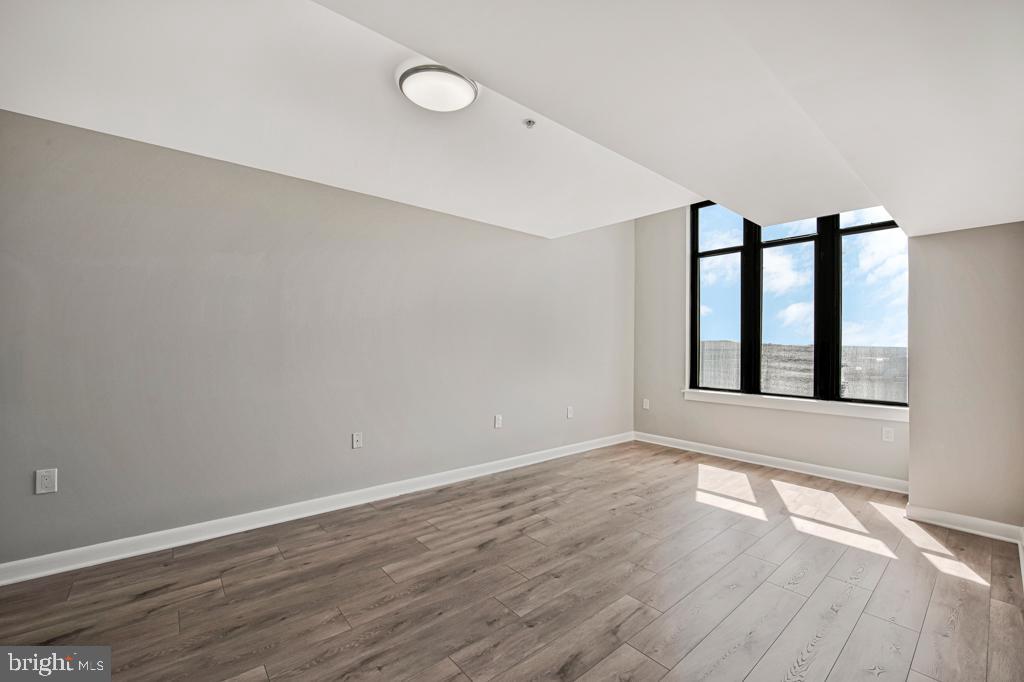 400 Massachusetts Avenue Northwest, Unit 1322 Washington, DC 20001 - Photo 9 of 37 a view of an empty room with wooden floor and window
