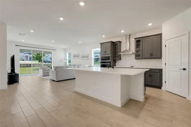 a kitchen with stainless steel appliances a refrigerator sink and cabinets
