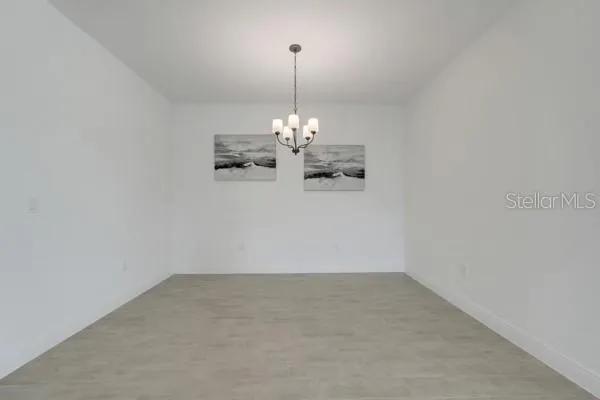 a view of a room with window and chandelier fan