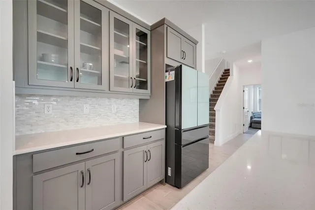 a kitchen with cabinets and a refrigerator