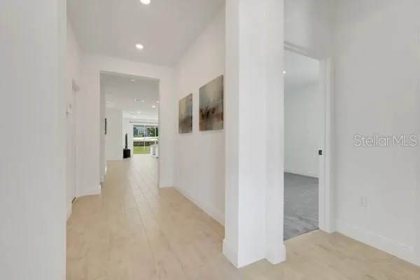 a view of a hallway with wooden floor