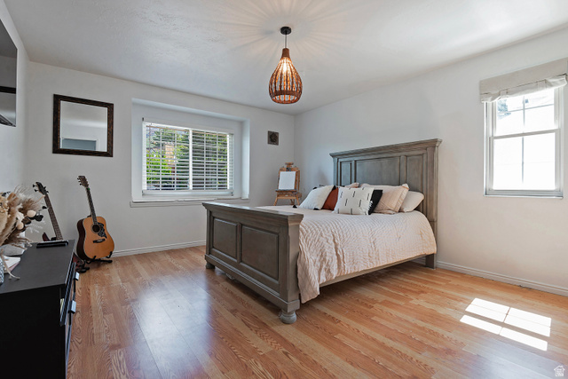 3310 Creek Road Salt Lake City, UT 84121 - Photo 25 of 49 Spacious room featuring wood-finish flooring, white walls, and a ceiling-mounted light fixture