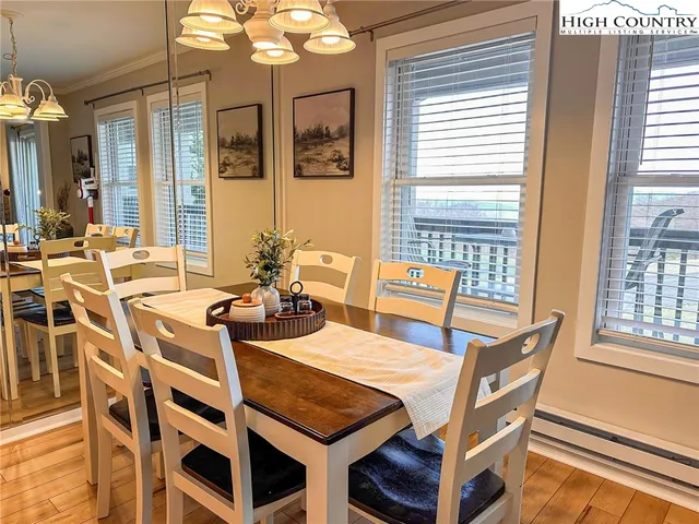 a view of a dining room with furniture and chandelier