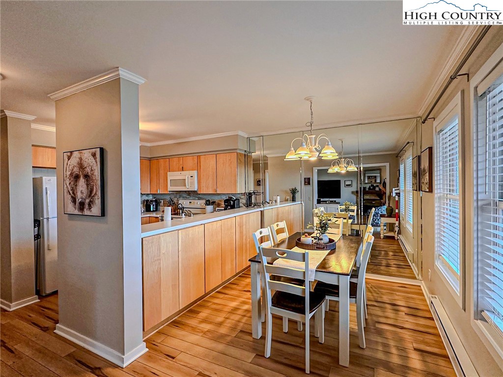 301 Pinnacle Inn Road, Unit 3320 Beech Mountain, NC 28604 - Photo 14 of 45 a view of a dining room with furniture window and wooden floor