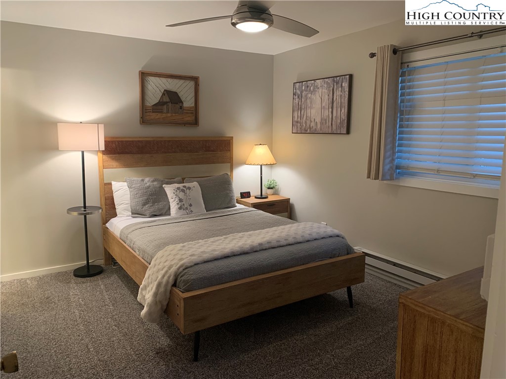 301 Pinnacle Inn Road, Unit 3320 Beech Mountain, NC 28604 - Photo 21 of 45 a bedroom with a bed and wall painting