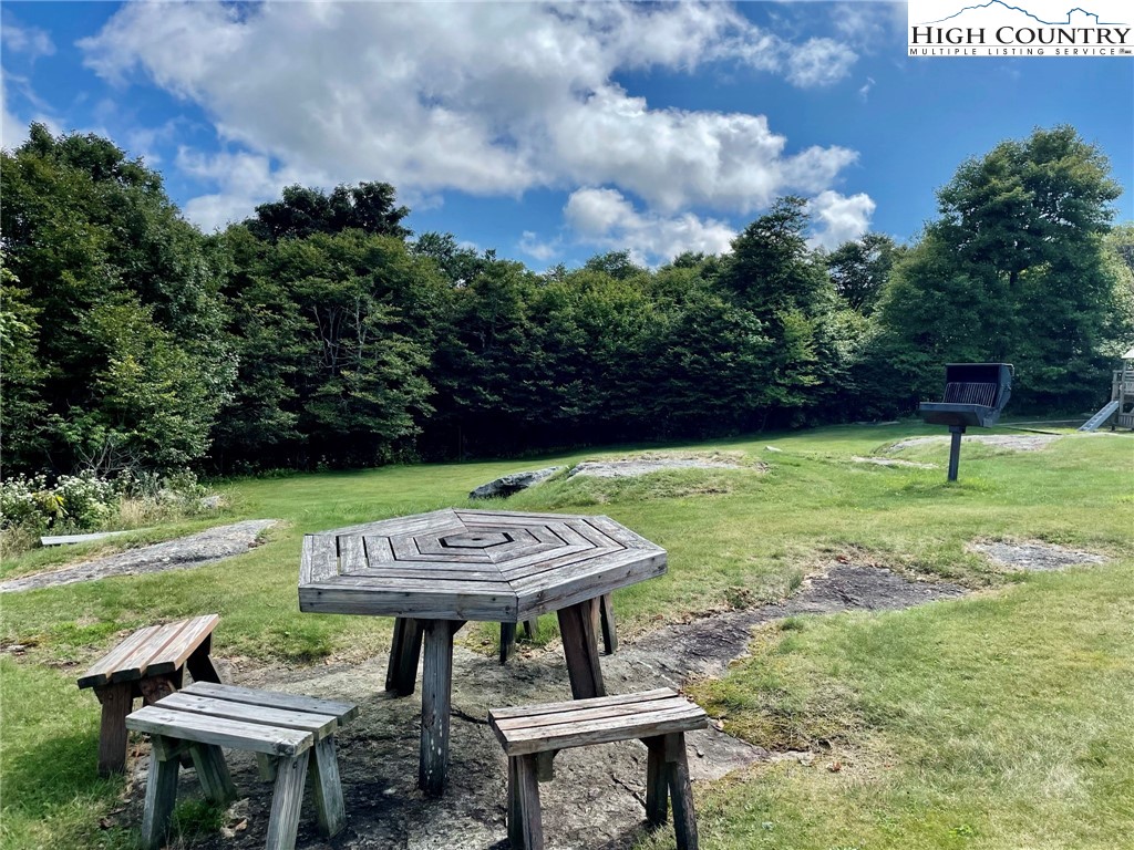 301 Pinnacle Inn Road, Unit 3320 Beech Mountain, NC 28604 - Photo 43 of 45 a view of a chairs and table in patio