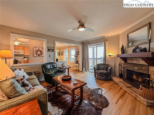 a living room with furniture fireplace and a large window