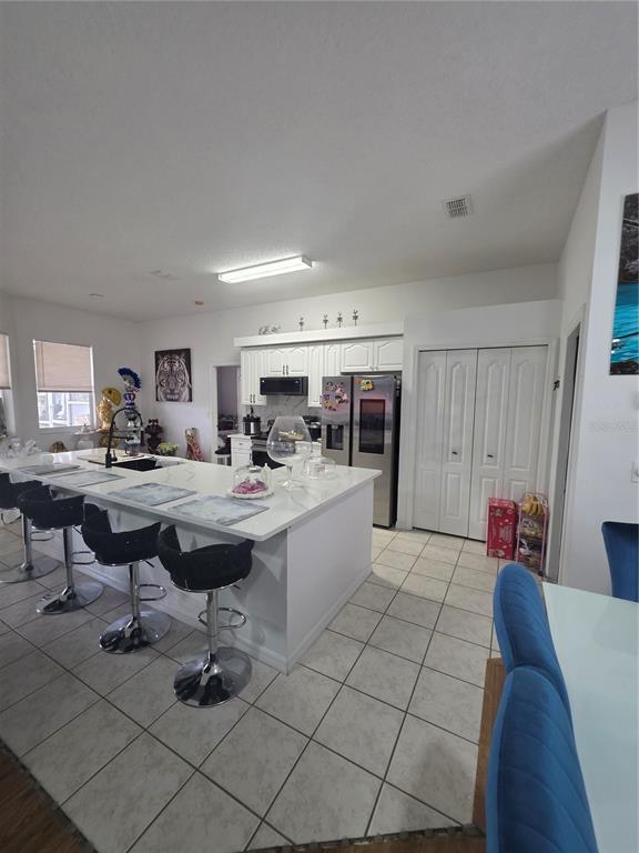 17820 Monteverde Drive Spring Hill, FL 34610 - Photo 15 of 42 a living room with furniture a rug and kitchen view