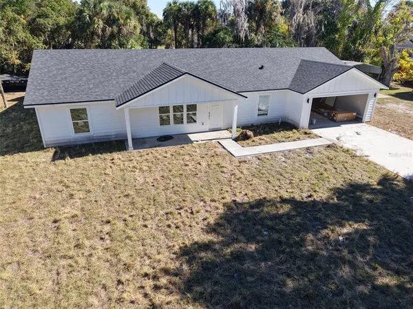 a aerial view of a house with a yard