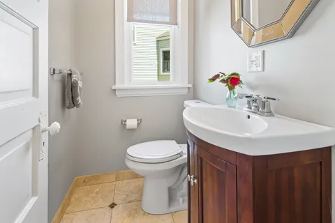 a bathroom with a sink a toilet and a mirror