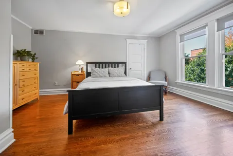 a bedroom with a bed and a dresser