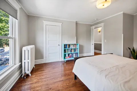 a spacious bedroom with a bed and a large window