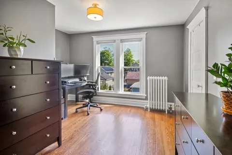 a view of a workspace with furniture and a window
