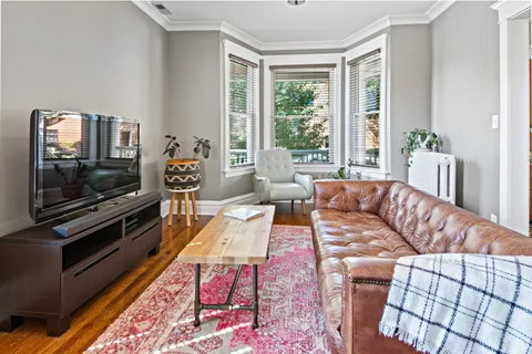 a living room with furniture fireplace and flat screen tv