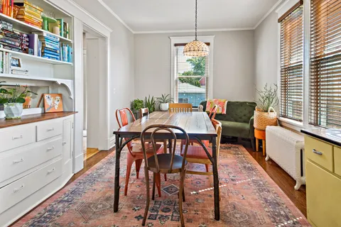 a view of a dining room with furniture window and wooden floor