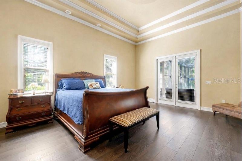 12012 Rambling Oak Boulevard Orlando, FL 32832 - Photo 19 of 49 a bedroom with a bed and wooden floor