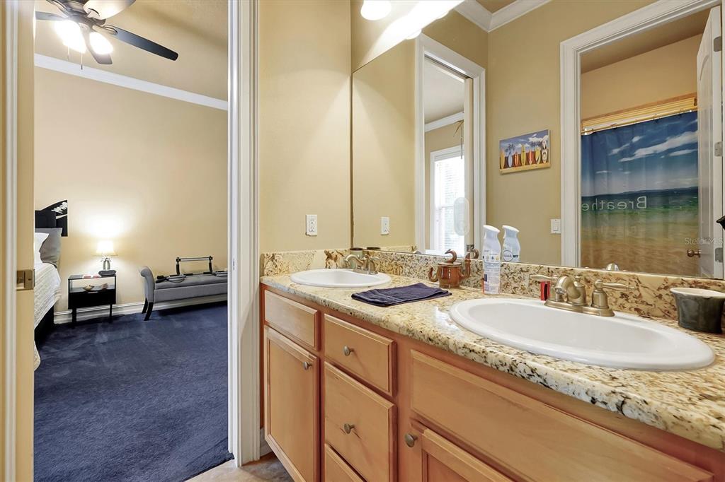 12012 Rambling Oak Boulevard Orlando, FL 32832 - Photo 26 of 49 a en suite bathroom with a granite countertop sink and a mirror
