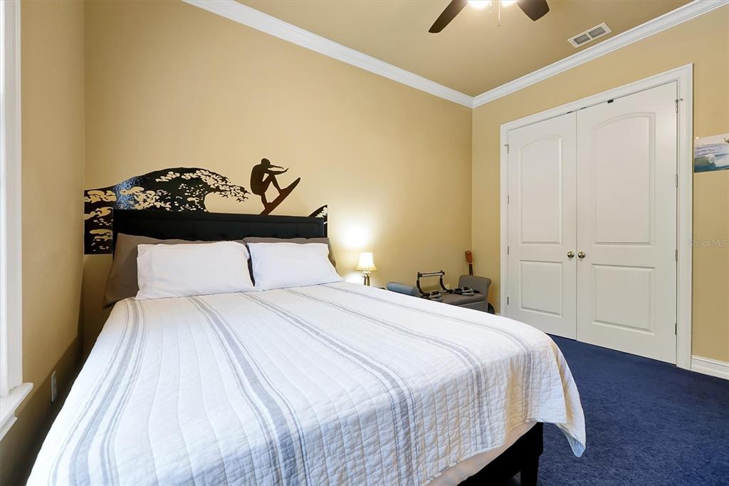 12012 Rambling Oak Boulevard Orlando, FL 32832 - Photo 29 of 49 a bedroom with a bed and a chandelier