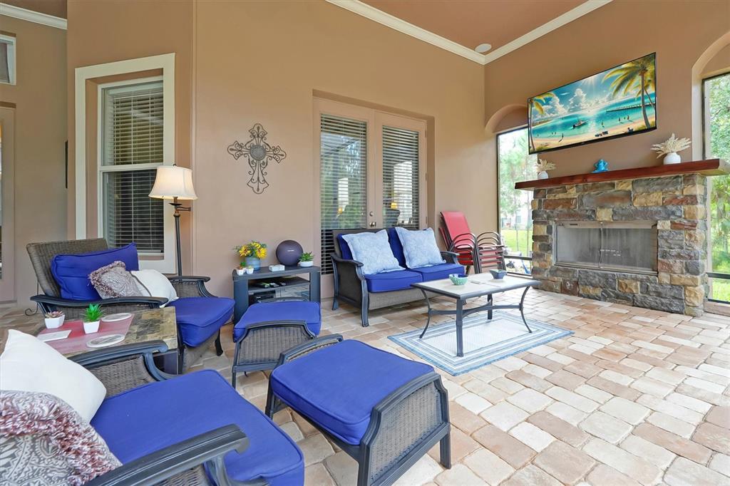 12012 Rambling Oak Boulevard Orlando, FL 32832 - Photo 37 of 49 a living room with furniture a fireplace and a flat screen tv