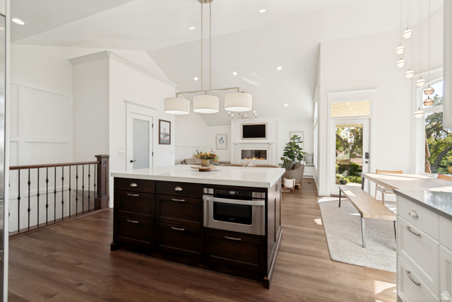1567 Ridgeview Circle Farmington, UT 84025 - Photo 12 of 55 Spacious kitchen island with dark wood cabinetry and integrated microwave