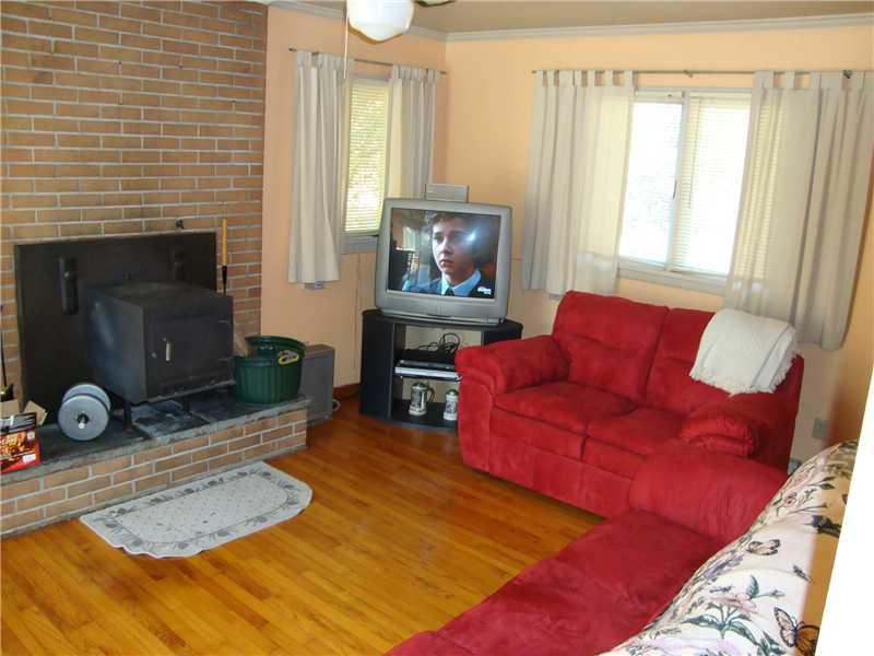263 Giesey Road Ligonier, PA 15658 - Photo 3 of 15 Living Room. Living room with hardwood floors, and woodburning fireplace.