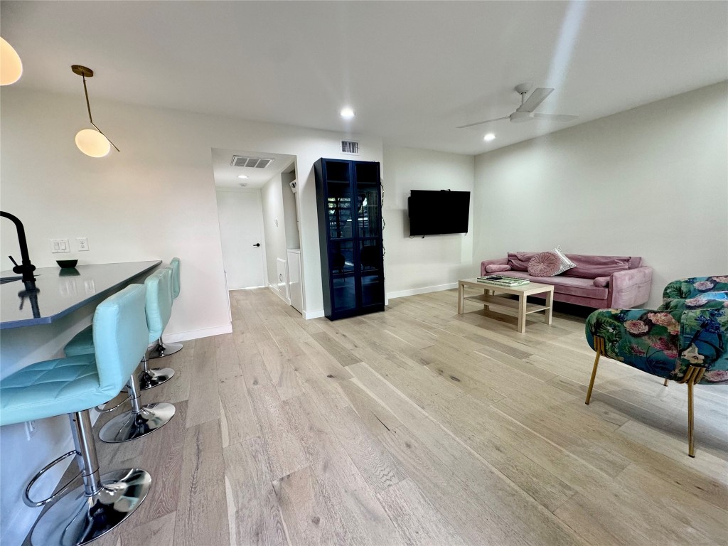 400 East 30th Street, Unit 101 Austin, TX 78705 - Photo 14 of 27 a living room with furniture and wooden floor