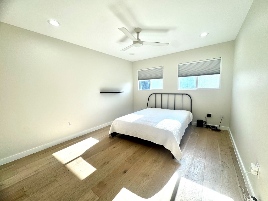 400 East 30th Street, Unit 101 Austin, TX 78705 - Photo 21 of 27 Bedroom with wood-type flooring, ceiling fan, and recessed lighting