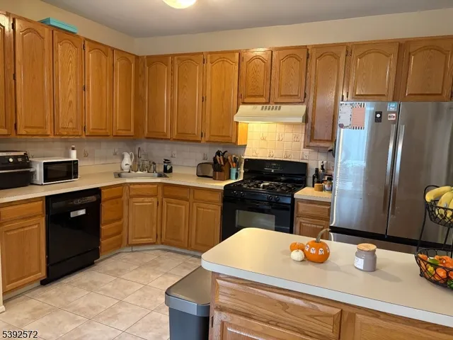 a kitchen with a sink appliances and cabinets
