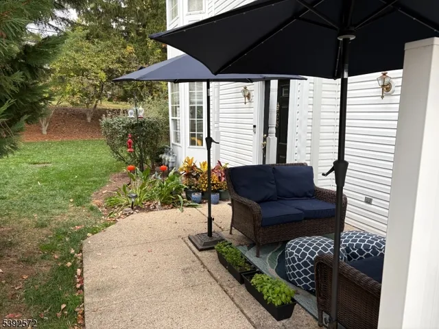 a view of a chair and tables in the back yard of the house