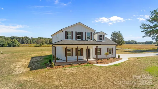 a view of a white house with a yard