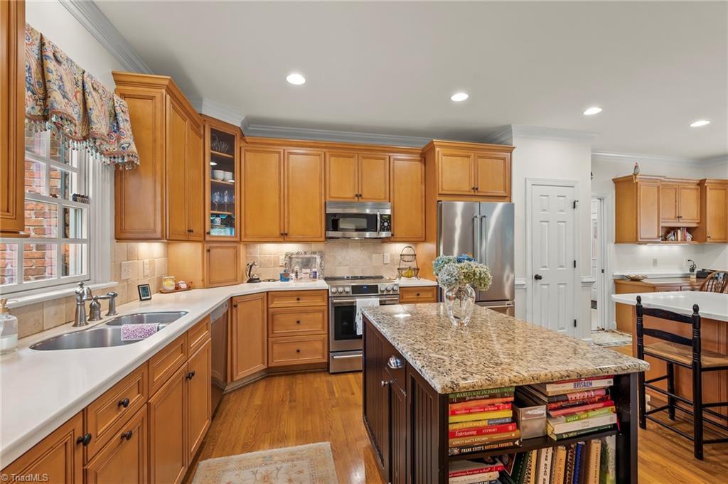 1457 Ridgemere Lane Winston-Salem, NC 27106 - Photo 7 of 39 The kitchen has stainless appliances, an island and hardwood floors
